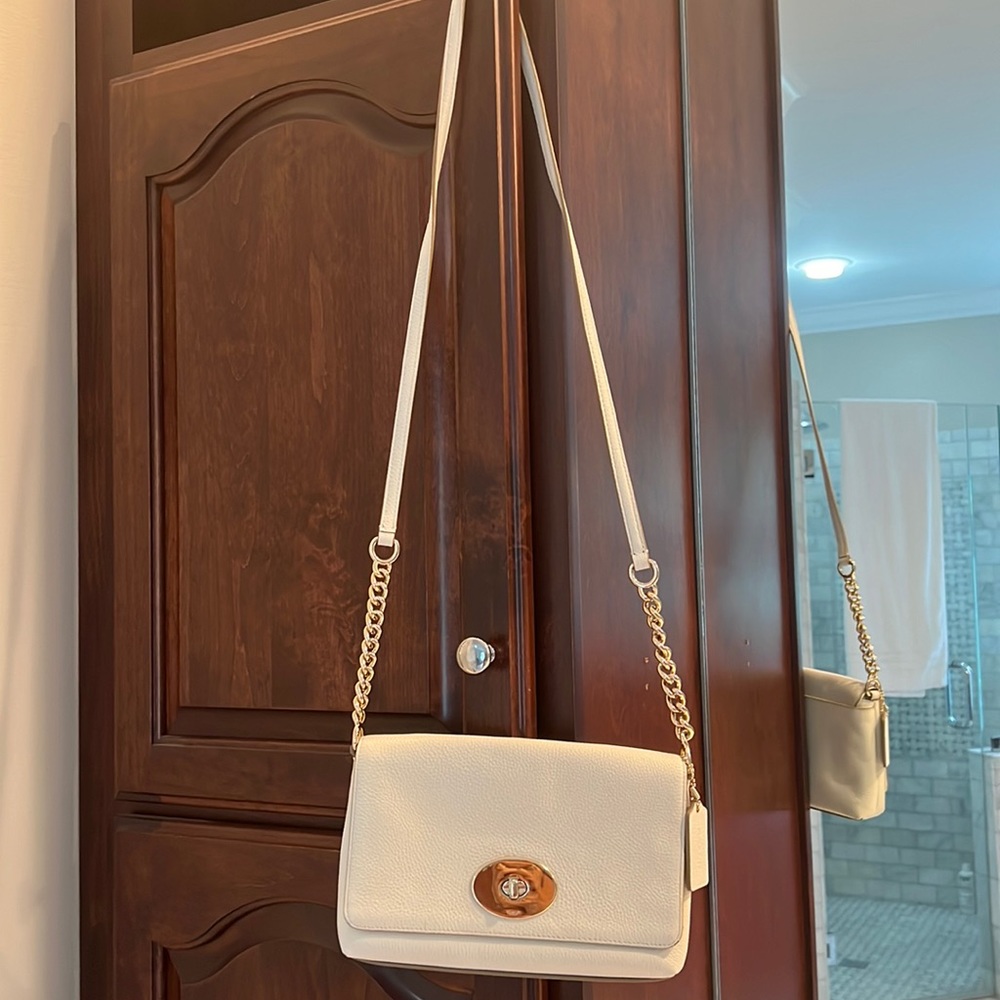 Elegant Ivory Coach purse with chain detail